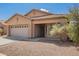 Neutral-colored single-Gathering home with a two-car garage and low-maintenance gravel landscaping at 12371 W Hadley St, Avondale, AZ 85323