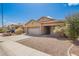 Single-Gathering home featuring a neutral exterior, a two-car garage, and a well-manicured front yard at 12371 W Hadley St, Avondale, AZ 85323