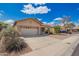 Attractive single-story home with low maintenance landscaping, a two-car garage, and ample driveway space at 12371 W Hadley St, Avondale, AZ 85323