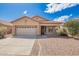 Charming single-story home with a two-car garage, desert landscaping, and inviting curb appeal at 12371 W Hadley St, Avondale, AZ 85323