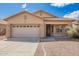 Well-maintained home with a front yard featuring desert landscaping and a two-car garage at 12371 W Hadley St, Avondale, AZ 85323