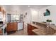 Functional kitchen featuring wood cabinetry, a stainless-steel sink, and a spacious countertop for meal prep at 12371 W Hadley St, Avondale, AZ 85323