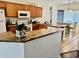 Well-equipped kitchen featuring wooden cabinets, modern appliances, and an adjacent dining area at 12371 W Hadley St, Avondale, AZ 85323