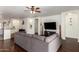 Open-concept living room showcasing a large sectional sofa and recessed wall decor at 12371 W Hadley St, Avondale, AZ 85323