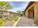 Backyard features a covered patio, rock garden, desert landscape, and privacy fence at 13204 W Via Dona Rd, Peoria, AZ 85383