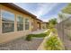 Backyard features a covered patio, rock garden, desert landscape, and privacy fence at 13204 W Via Dona Rd, Peoria, AZ 85383