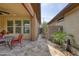 Covered patio extends to a landscaped backyard with a rock area and turf at 13204 W Via Dona Rd, Peoria, AZ 85383