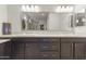 Bathroom featuring double sinks, spacious vanity, and stylish lighting fixtures at 13204 W Via Dona Rd, Peoria, AZ 85383