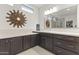 A contemporary bathroom featuring a white countertop, stylish brown cabinetry at 13204 W Via Dona Rd, Peoria, AZ 85383
