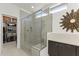 Modern bathroom with glass-enclosed shower, built-in bench, and designer tile work at 13204 W Via Dona Rd, Peoria, AZ 85383