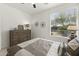 Brightly lit bedroom with a large window and light tile flooring at 13204 W Via Dona Rd, Peoria, AZ 85383