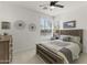 Bright bedroom features a ceiling fan, tile floors and two large windows at 13204 W Via Dona Rd, Peoria, AZ 85383