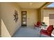 Cozy covered front porch with a decorative door, comfortable seating, and modern desert decor at 13204 W Via Dona Rd, Peoria, AZ 85383
