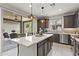 Stylish kitchen with a central island, modern appliances, and a sliding glass door to the patio at 13204 W Via Dona Rd, Peoria, AZ 85383