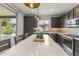 Modern kitchen featuring a large island, stainless steel appliances, and dark wood cabinetry at 13204 W Via Dona Rd, Peoria, AZ 85383