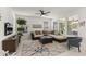 Bright living room featuring a comfortable sectional sofa, large windows, and stylish decor at 13204 W Via Dona Rd, Peoria, AZ 85383