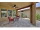 Outdoor patio space with a ceiling fan and table with desert landscaping views at 13204 W Via Dona Rd, Peoria, AZ 85383