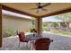 Cozy covered patio with a ceiling fan and dining set overlooking desert landscaping at 13204 W Via Dona Rd, Peoria, AZ 85383