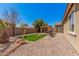 Landscaped backyard featuring a pergola, a grill and various trees at 15573 W Laurel Ln, Surprise, AZ 85379
