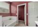 Bathroom boasts a soaking tub, tiled floors and a decorative plant at 15573 W Laurel Ln, Surprise, AZ 85379