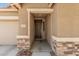 Close-up shot of a front door and the house number, framed by stone accents at 15573 W Laurel Ln, Surprise, AZ 85379