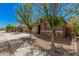 Street view of a single story home with desert landscaping, a stone facade, and a two-car garage at 15573 W Laurel Ln, Surprise, AZ 85379
