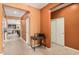 Inviting hallway leading to the main living areas, adorned with neutral tile flooring at 15573 W Laurel Ln, Surprise, AZ 85379