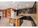 Large kitchen features a granite island, stainless appliances, and ample dark wood cabinetry at 15573 W Laurel Ln, Surprise, AZ 85379
