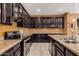 Spacious kitchen features granite countertops, stainless appliances and tile flooring at 15573 W Laurel Ln, Surprise, AZ 85379