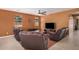 Comfortable living room offering plush seating, neutral walls, and a ceiling fan at 15573 W Laurel Ln, Surprise, AZ 85379