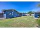 Wide view of backyard featuring grass, fencing and patio at 1740 W Crescent Ave, Mesa, AZ 85202