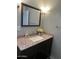 Bathroom vanity with granite countertops, a decorative mirror, and modern lighting fixtures at 1740 W Crescent Ave, Mesa, AZ 85202