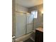 Tiled bathroom with a sliding glass door shower and granite countertop sink at 1740 W Crescent Ave, Mesa, AZ 85202