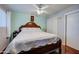 Charming bedroom features a beautiful bed frame, a ceiling fan, wood floors, and white walls at 1740 W Crescent Ave, Mesa, AZ 85202