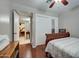 Bedroom with wood floors, neutral walls, ceiling fan, closet, sewing machine and natural light at 1740 W Crescent Ave, Mesa, AZ 85202