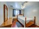 Bright bedroom features a wood bed frame, matching bedside tables, and a large window with blinds at 1740 W Crescent Ave, Mesa, AZ 85202