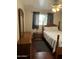 Cozy bedroom with hardwood floors, a double bed, and dark curtains at 1740 W Crescent Ave, Mesa, AZ 85202