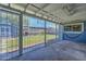 Enclosed patio with concrete flooring and metal security gate, backyard views at 1740 W Crescent Ave, Mesa, AZ 85202