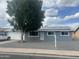 Charming single-story home featuring solar panels, gravel landscaping, and a mature shade tree at 1740 W Crescent Ave, Mesa, AZ 85202