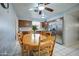 Eat-in kitchen with wood cabinets, stainless appliances, white tile floor, and ceiling fan at 1740 W Crescent Ave, Mesa, AZ 85202