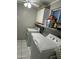 Functional laundry room with washer, dryer, and ample storage space with shelves at 1740 W Crescent Ave, Mesa, AZ 85202