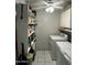 Practical laundry area with white appliances, storage shelves, and plenty of room for laundry tasks at 1740 W Crescent Ave, Mesa, AZ 85202