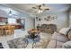 Open-concept living and dining area featuring neutral colors, ceiling fans, and laminate wood cabinets at 1740 W Crescent Ave, Mesa, AZ 85202