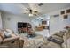 Comfortable living room with gray and beige decor, ceiling fan, and open view to the dining area at 1740 W Crescent Ave, Mesa, AZ 85202