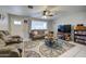 Bright living room with tile floors, comfortable seating, ceiling fan, and media console at 1740 W Crescent Ave, Mesa, AZ 85202