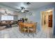 Open concept living space with eat-in kitchen leading to a cozy living room with tile flooring at 1740 W Crescent Ave, Mesa, AZ 85202