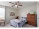 Comfortable bedroom with carpet flooring, a ceiling fan, and natural light at 17538 W Marshall Ln, Surprise, AZ 85388