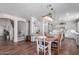 Open dining area with hardwood floors, stylish pendant lighting, and a clear view of the kitchen at 17538 W Marshall Ln, Surprise, AZ 85388