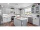 Modern kitchen with white cabinets, quartz countertops, stainless steel appliances, and an island at 17538 W Marshall Ln, Surprise, AZ 85388