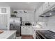 Well-lit kitchen featuring stainless steel appliances, white cabinets, and quartz countertops at 17538 W Marshall Ln, Surprise, AZ 85388